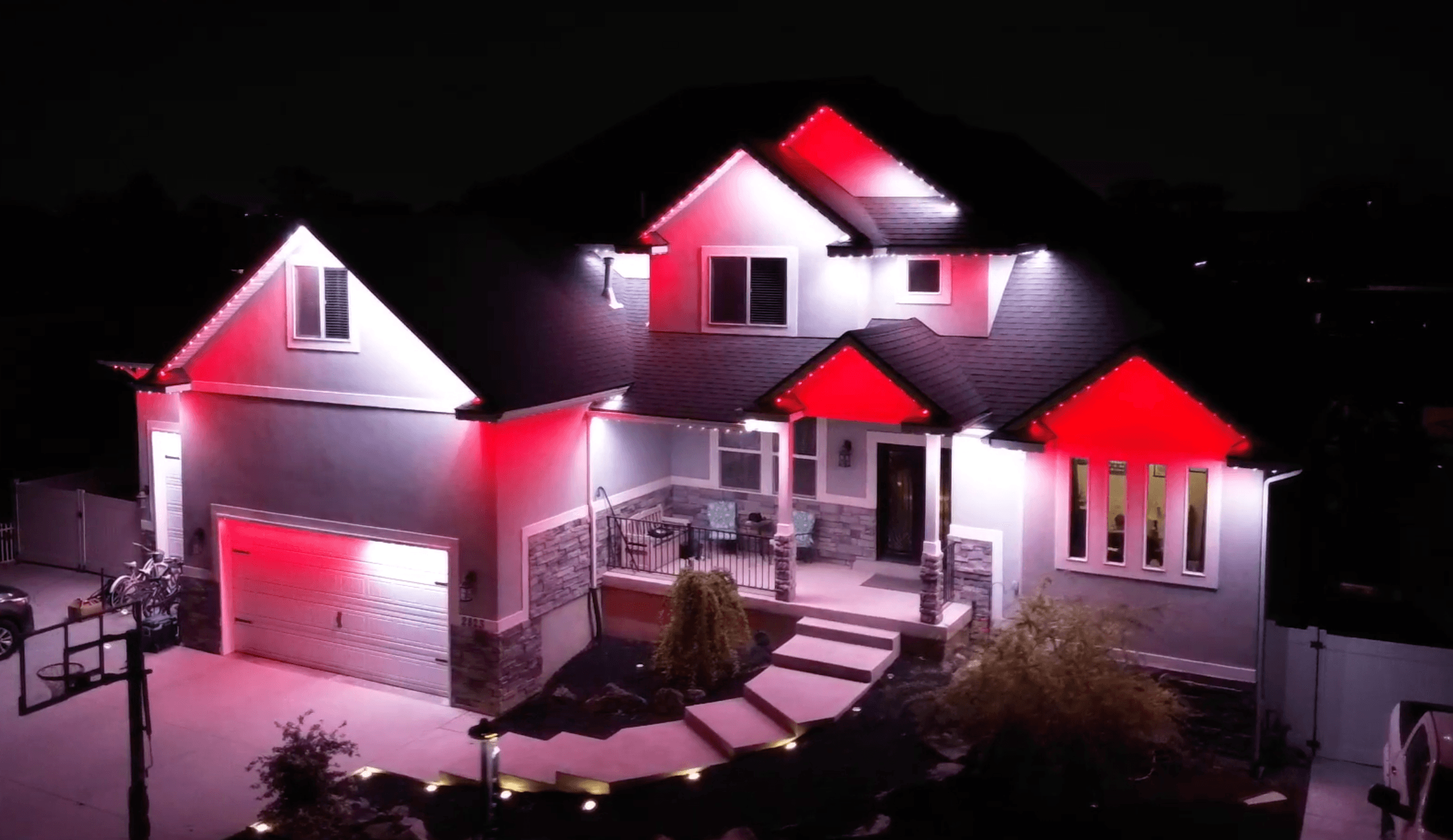 Permanent LED lighting on a West Jordan home glowing red and white