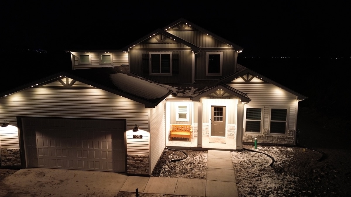 Aerial view of a well-lit Salt Lake City home showing the impact of permanent lighting on curb appeal