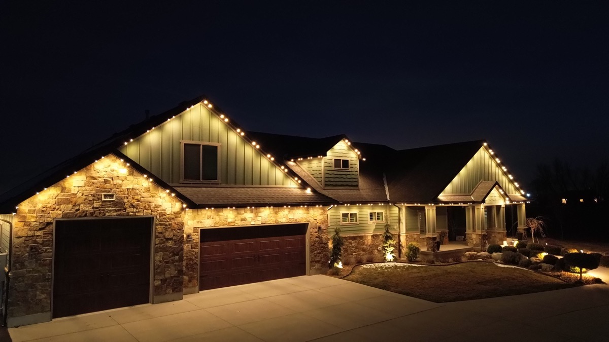 Clean permanent lighting track mounted along the roofline of a Wasatch Front home