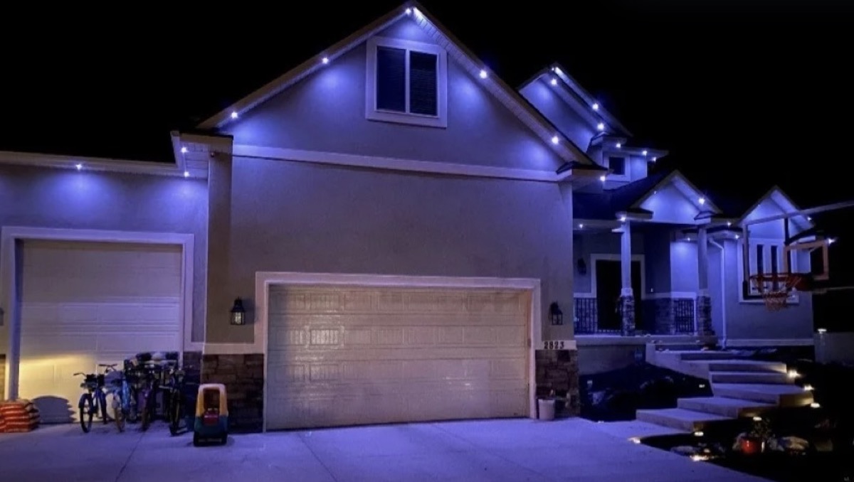 TruLight permanent lighting displaying blue and white colors on a Salt Lake City home for game day
